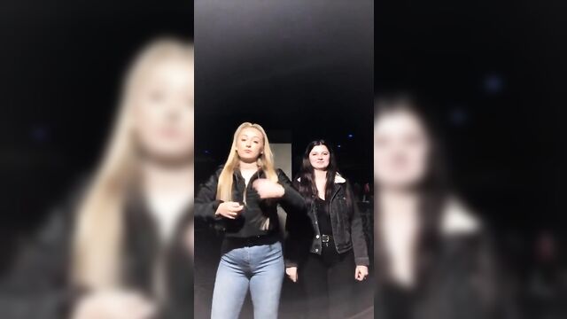Blondie with big boobs promotes her tiktok account wearing a puffer jacket