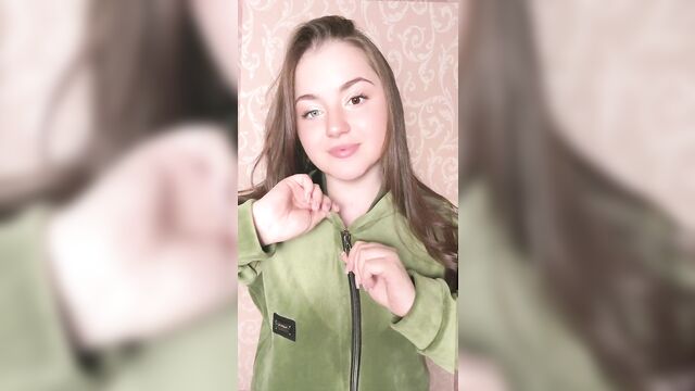 A sexy cleavage teaser in a green jacket, perky tits spilling out passion