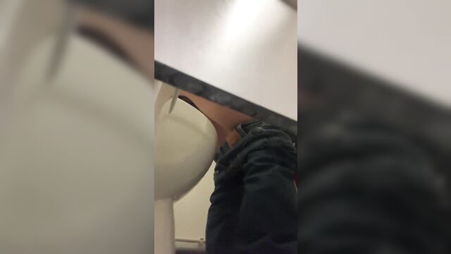 A girl pees in the toilet, but her ass is visible